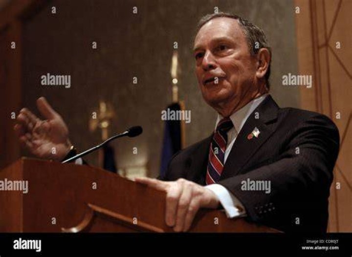 Michael Bloomberg speaking at a conference meeting.